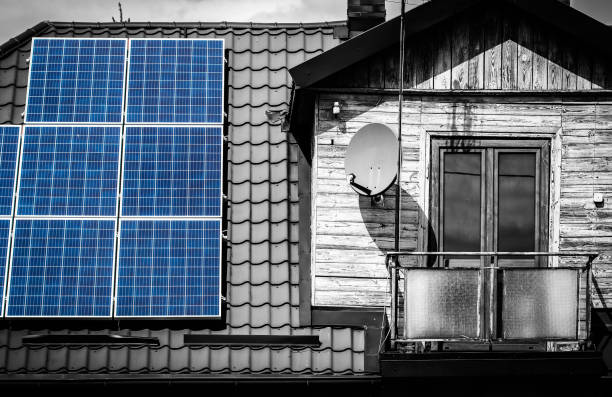 Solar panels on old wooden house stock photo