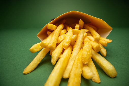 French fries on a green background