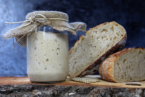 Sourdough Baker's yeast is active. Beginning Maya. The concept of a healthy diet. On a wooden background and in a jar