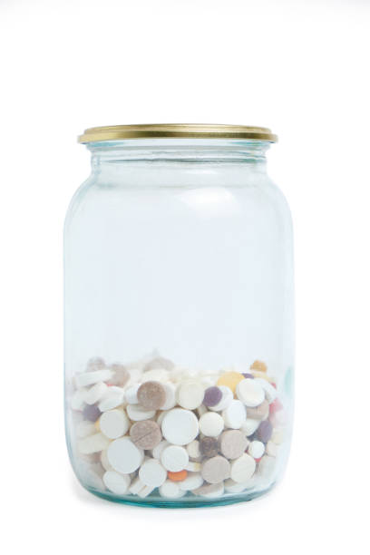 istock Glass jar with pills, on a white background. Stock medicines. 1404439237