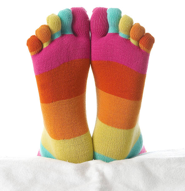 due piedi in calze autoreggenti - sock wool multi colored isolated foto e immagini stock