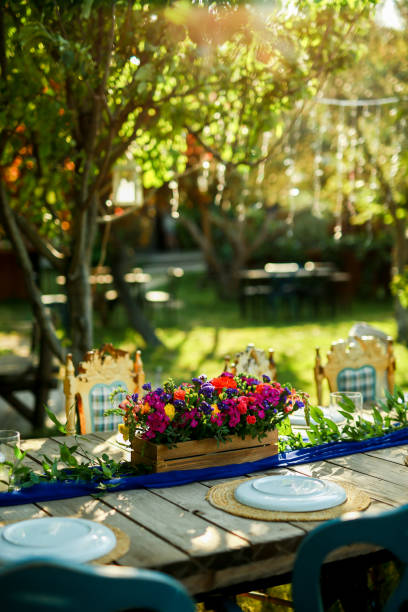 istock Rustic wedding style, Wooden dining table with flowers decoration and tableware 1404439526