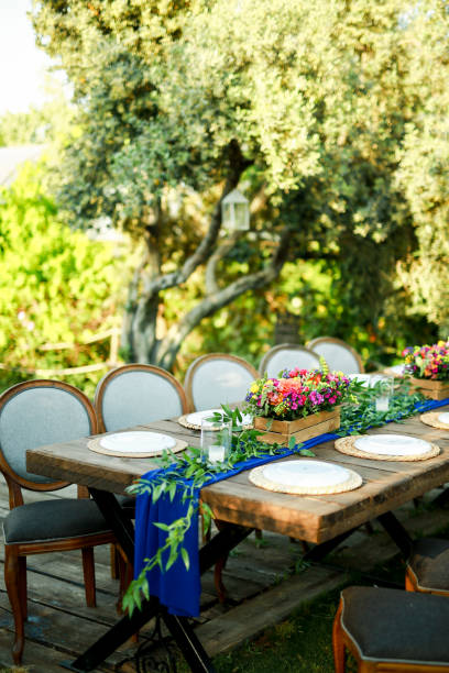 istock Rustic wedding style, Wooden dining table with flowers decoration and tableware 1404440655