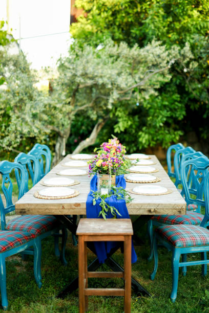 istock Rustic wedding style, Wooden dining table with flowers decoration and tableware 1404440883