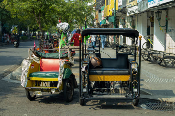 Two Pedicab Units Yogyakarta, Indonesia, May 2022 - Two pedicab units on the side of Malioboro road no rickshaws sign stock pictures, royalty-free photos & images