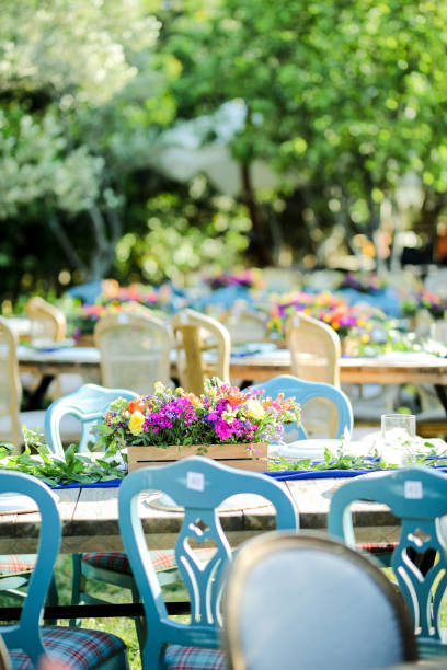 istock Rustic wedding style, Wooden dining table with flowers decoration and tableware 1404441249