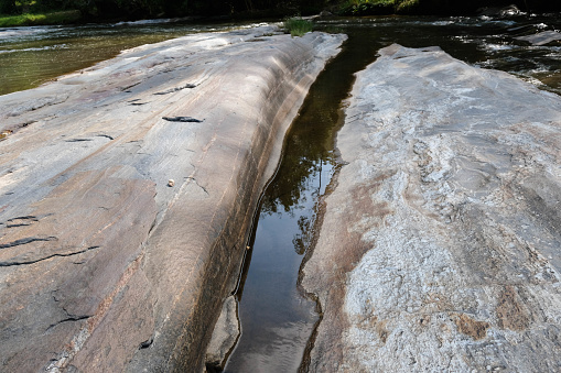 Rocky landscape on the bank of a natural river in a mountain forest in northern Thailand. Stone and ecology concept.