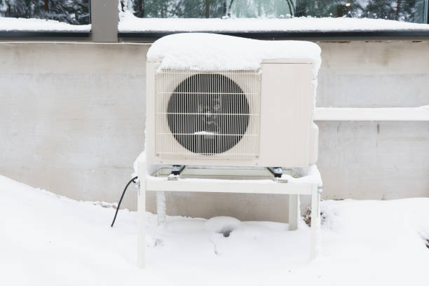 The outdoor unit of an air-source heat pump The outdoor unit of an air-source heat pump after a winter storm. condenser stock pictures, royalty-free photos & images