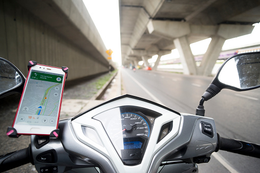 Bangkok, Thailand,  Oct,07,2019:Smartphone on motorcycle handlebar holder for safety and use it to view the navigation map