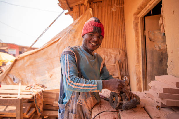 istock An african carpenter uses a chainsaw shaper in his workshop while working. 1404442337