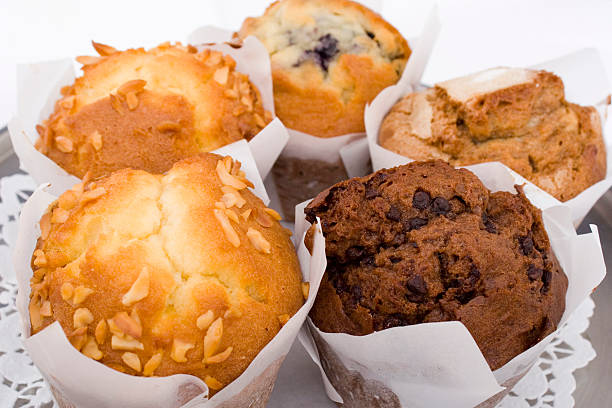 Close up of 5 different breakfast muffins, on a lace doily  stock photo