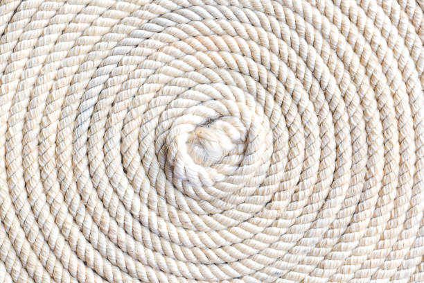 Macro rope texture,Super close up of a thick rope in shape of a spiral,Photo of an old vintage rope. Natural warm light Macro rope texture,Super close up of a thick rope in shape of a spiral,Photo of an old vintage rope. Natural warm light mooring line stock pictures, royalty-free photos & images