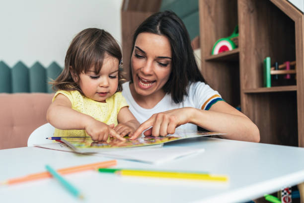 istock Mother and daughter reading book 1404446360