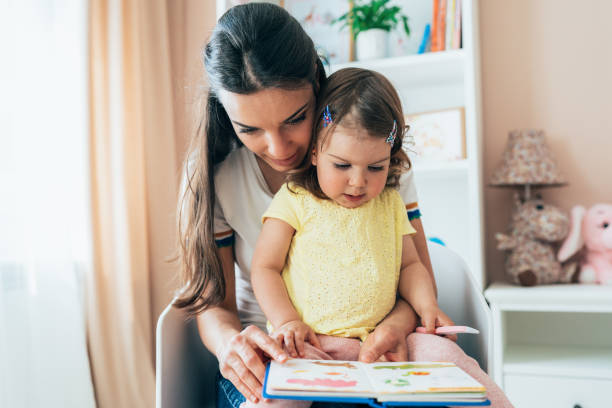 istock Mother and daughter reading book 1404446368