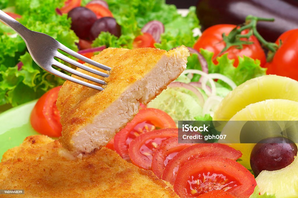 Fish dinner with a large salad and fruit cutlet with vegetables ,potatoes and champignons Appetizer Stock Photo