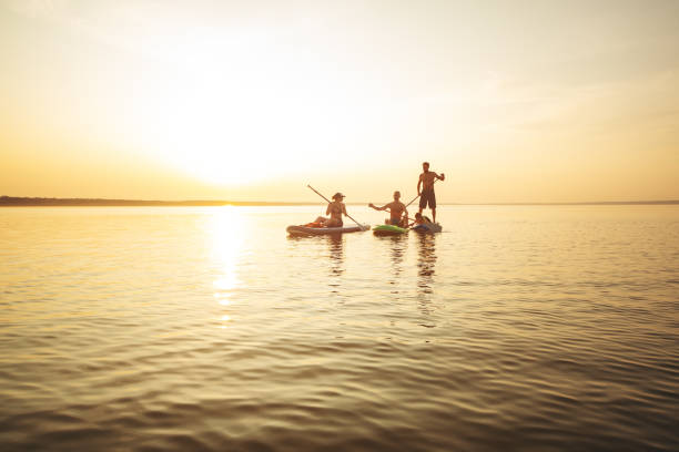istock Group of people sup boarding at sunset 1404448831