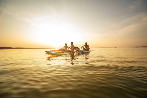 istock Group of people sup boarding at sunset 1404449404