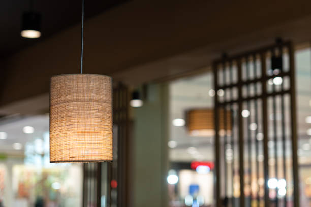 A lighting lamp with canvas fabric weave textured cover. Interior decoration object photo. Selective focus.