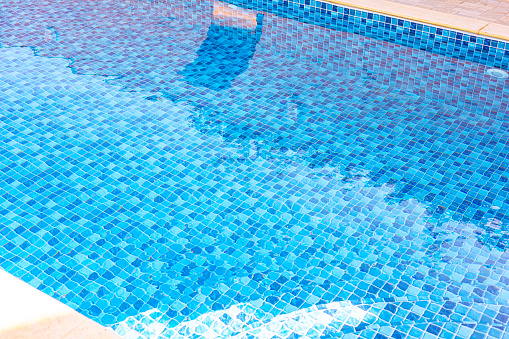 Vinyl lined pool. Outdoor photo of a mosaic-patterned residential swimming pool.