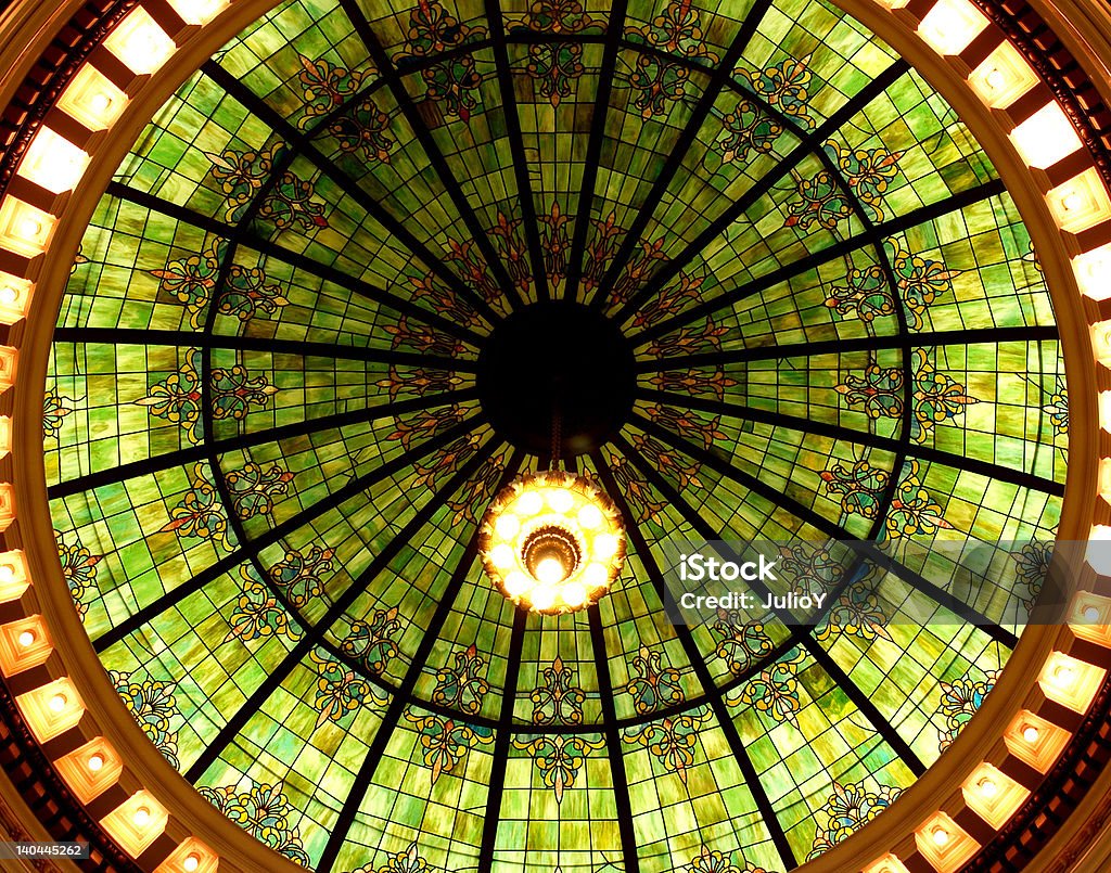 Courthouse domed green stained glass ceiling. Courthouse domed green stained glass ceiling & light fixture creates interesting pattern.      Architecture Stock Photo