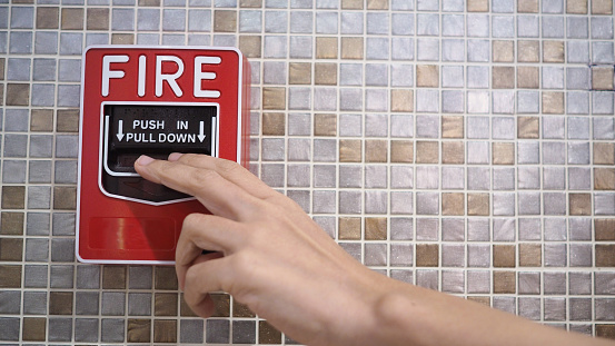 Emergency of Fire alarm or alert or bell warning equipment and hand.In the building for safety.