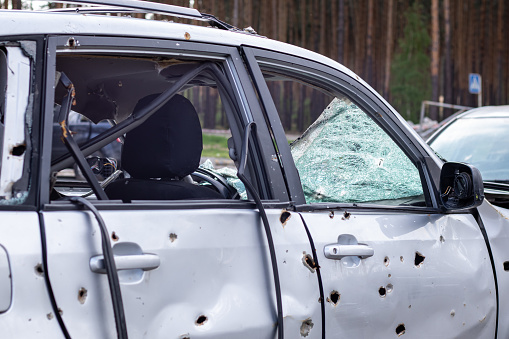 Car riddled with bullets. War of Russia against Ukraine. A car of civilians shot by the Russian military during the evacuation of women and children. Traces of bullets and fragments of shells
