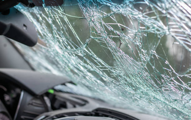 istock Damaged car window after an accident. Broken windshield as a result of an accident, inside view. Cabin interior details, view from the cab. Safe movement. Broken windshield. Glass crack and damage. 1404454006