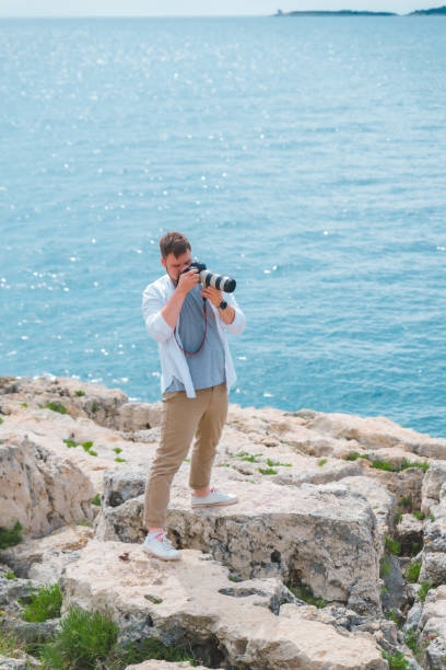 istock man with professional dslr camera taking picture of seashore 1404455927