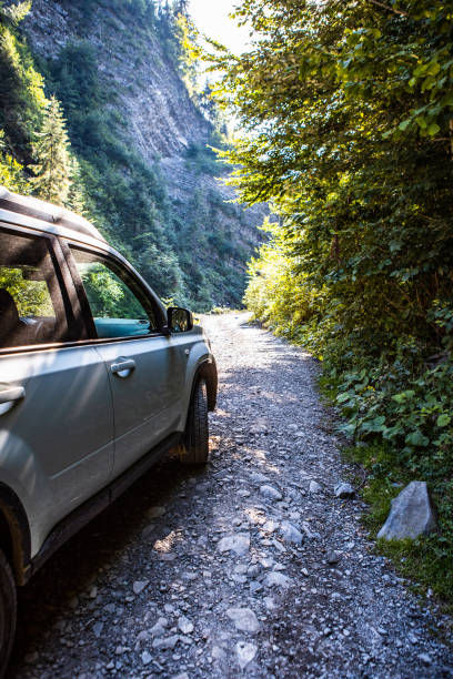 suv car at mountains trail summertime