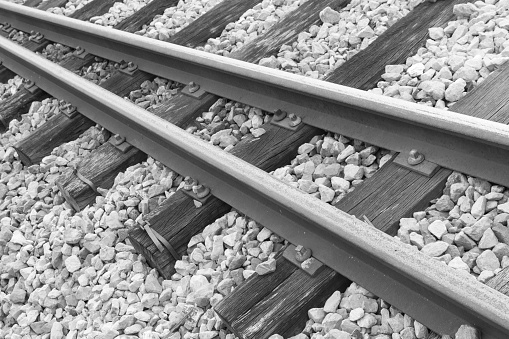 Rail tracks and sleepers. Ballast. Transportation. Train. Abstract. Black and white