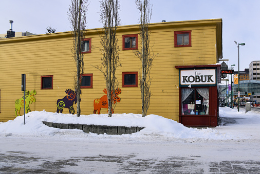 Anchorage, Alaska, USA: Kobuk Coffee Co., downtown shop and café - building decorated with moose - Kimball building, built in 1915, the Kimball building, on Town Square Park at the corner of 5th Avenue and E Street - snow on the sidewalk.