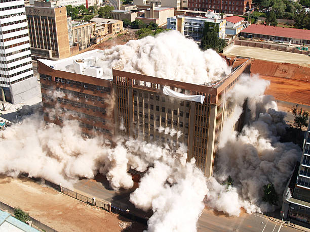 Building implosion in Johannesburg, South Africa Third in the series of demolition by implosion of four buildings in one block in Johannesburg to clear the way for a new parking lot for the new Gautrain underground railway line. collapsing stock pictures, royalty-free photos & images