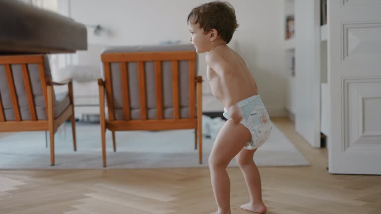 Boy and toddler dancing at home