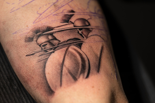 Close up view, of a tattoo of an spartan warrior. High quality photo