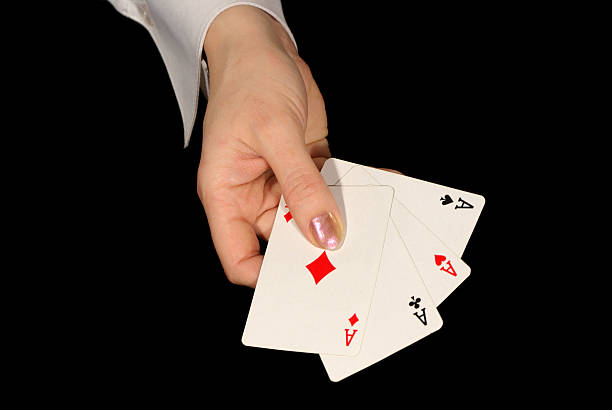 istock four aces in female hand on black 140446456