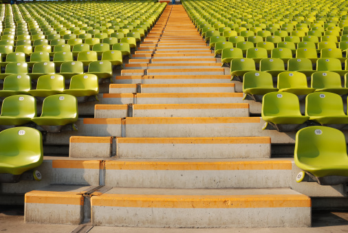 stadium steps and rows of green seats