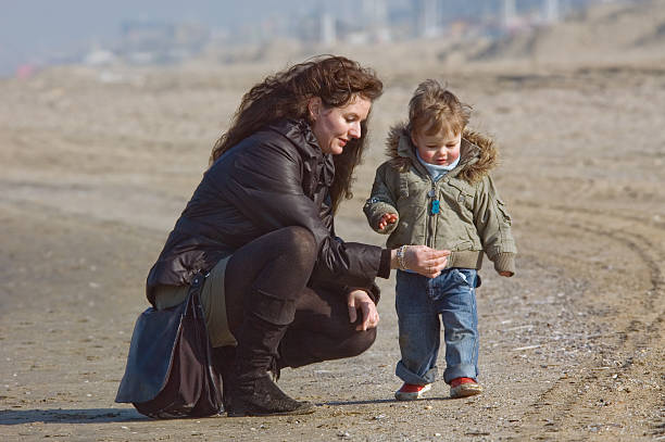 istock mother and cute boy on the beach 140446619