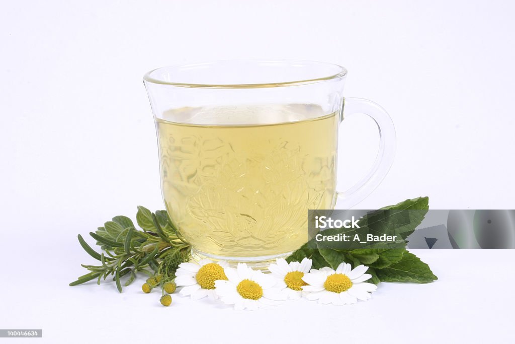 Herb_tea a cub of herbal tea, with mix of green herbs around it, on a white background. Animal Stock Photo