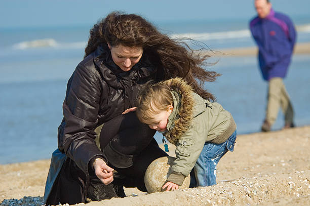 istock mother and cute boy on the beach 140446651