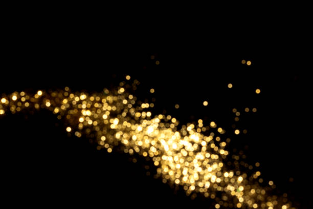 istock Golden blurred bokeh lights on black background 1404468178
