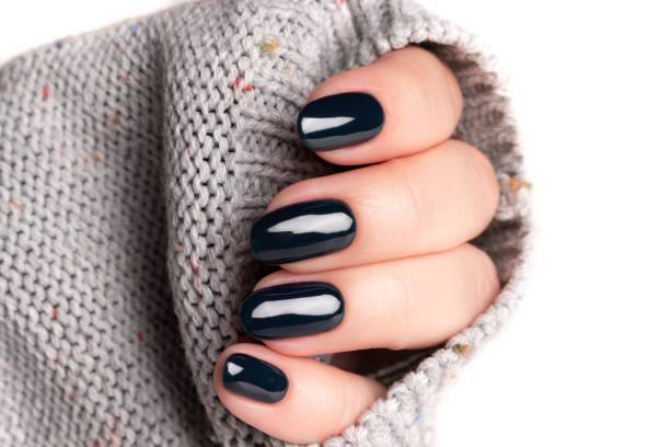 istock Female hand with black nails 1404468423