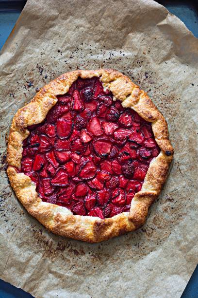 French dessert Galette with shortbread and strawberries. Open pie with berries.