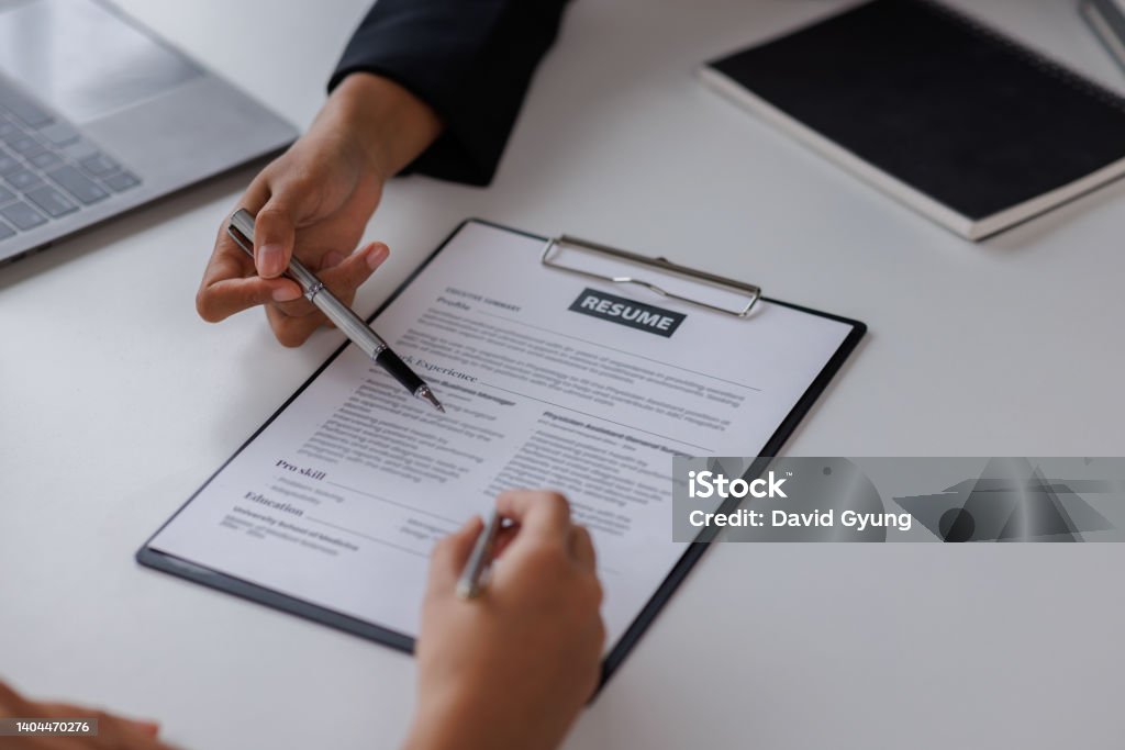 Examiner reading a resume during job interview at office Business and human resources concept. Résumé Stock Photo