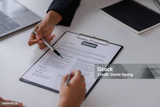 Examiner Reading A Resume During Job Interview At Office Business And Human Resources Concept Stock Photo - Download Image Now