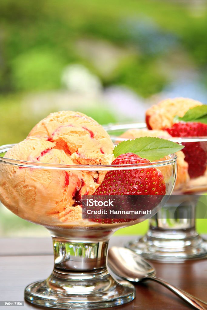 Summertime icecream Summertime! Mango or peach icecream sundae with strawberries.  Ice Cream Stock Photo