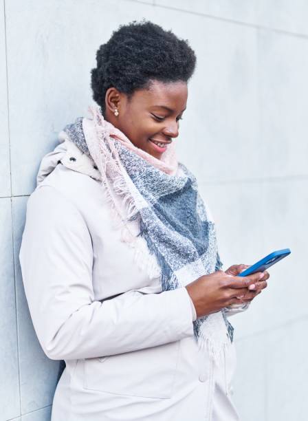 istock African american woman smiling confident using smartphone at street 1404471663