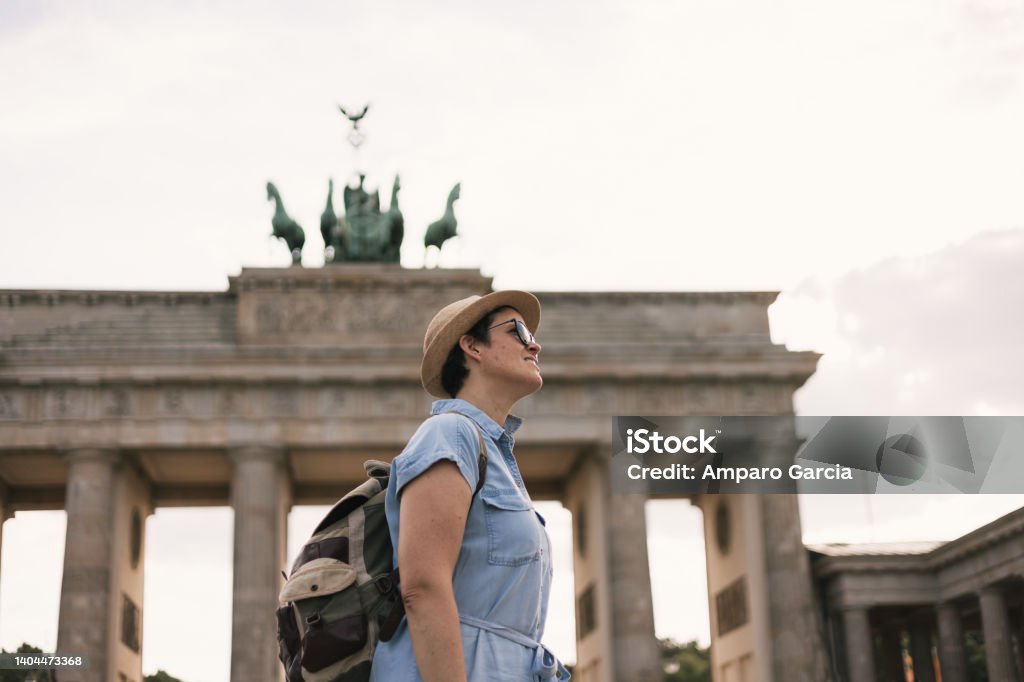 Travel and tourism concept A tourist with a backpack visiting the Brandenburg Gate in Berlin in Germany 40-44 Years Stock Photo