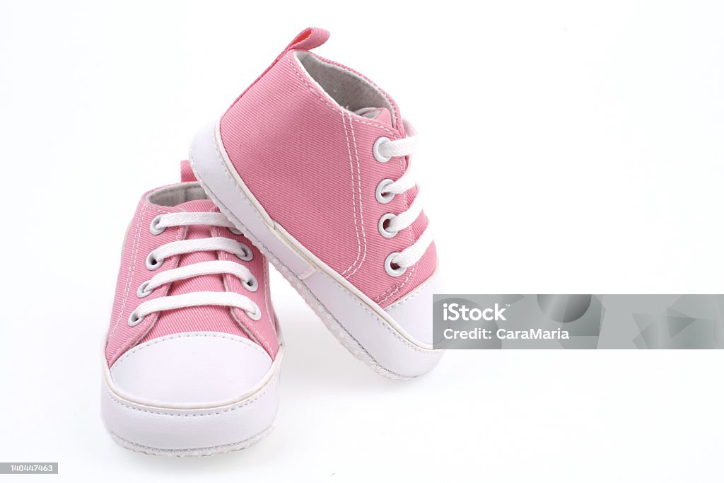 Little light pink shoes for babies pink baby shoes on white background Baby Booties Stock Photo