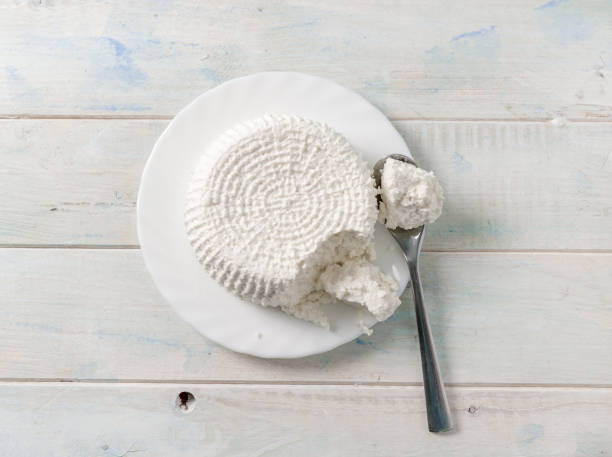 istock Plate with cottage cheese, spoon in cheese, topview 1404475066