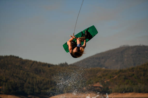 istock energy guy makes dangerous stunts jumping and flips on wakeboard over splashing wave 1404475550